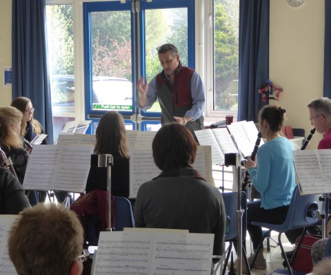 Band practising at music workshop with conductor Major Ian