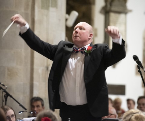 Conductor with audience in background at Wimborne Minster