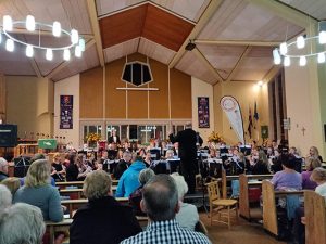 Audience listening to band play at autumn concert