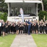 Band members standing in front of Bournemouth bandstand