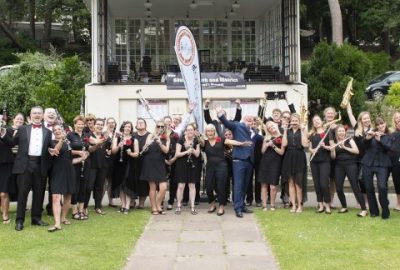 Band members standing in front of Bournemouth bandstand