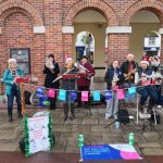 Band busking Saxon Square Christchurch contributing to money raised for Cancer Research UK