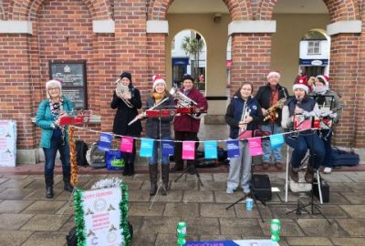Band busking Saxon Square Christchurch contributing to money raised for Cancer Research UK