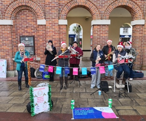 Band busking Saxon Square Christchurch  contributing to money raised for Cancer Research UK