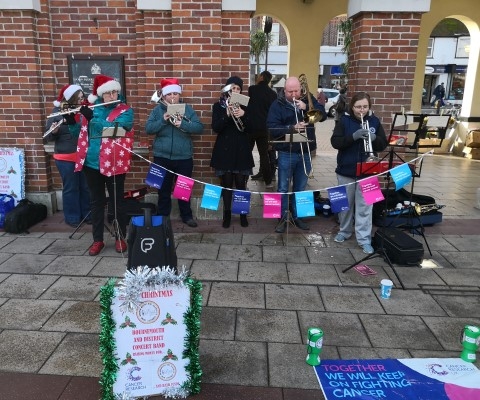 Band busking Saxon Square Christchurch contributing to money raised for Cancer Research UK