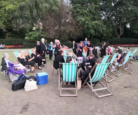 Band sitting on deckchairs in circle