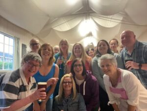 Band members enjoying a skittles night social smiling for camera