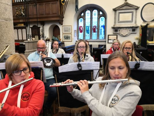 Close up of woodwind and brass players at church rehearsal