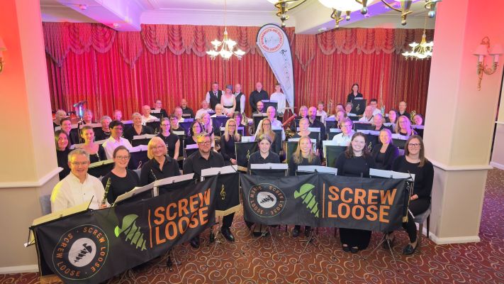 Band and Screw Loose smiling at camera