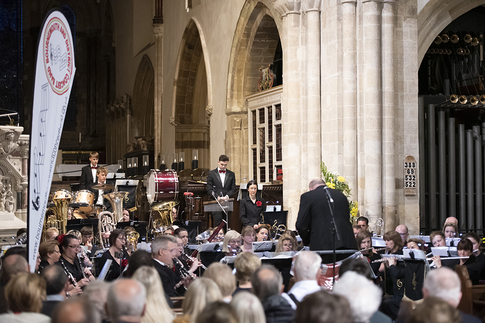 Drummer and percussionists playing with band at Wimborne Minster
