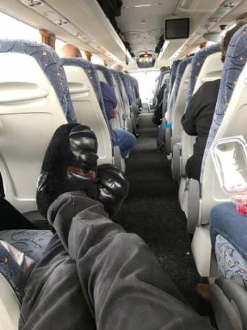 Bandmaster wearing gorilla slippers on coach
