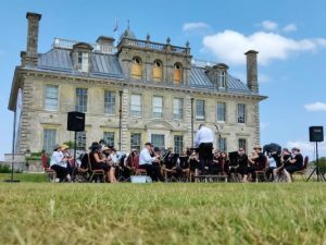 Band performing at Kingston Lacy in front of house