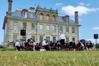 Band performing at Kingston Lacy in front of house