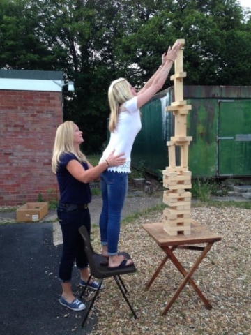 Two band members playing outdoor jenga
