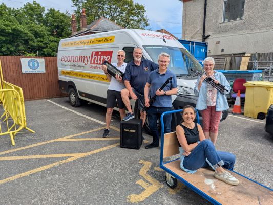 Set-up crew unloading equipment from van