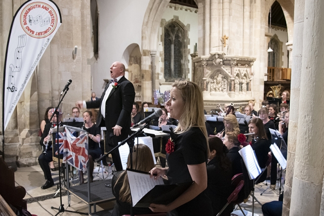 singer-conductor-band-wimborne820 Our singer and conductor performing with the band in Wimborne Minster