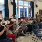 Our brass and percussion section at band rehearsal in school hall