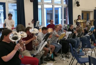 Our brass and percussion section at band rehearsal in school hall